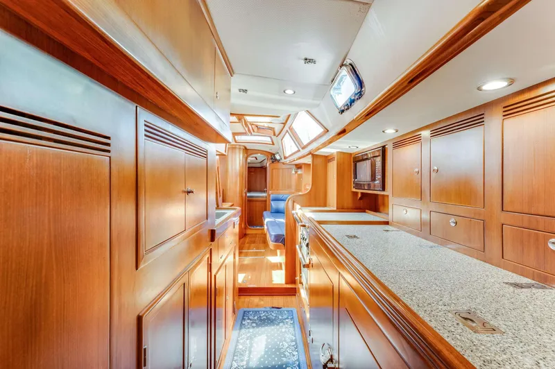 Liberte' Yacht Photos Pics Luxurious interior of 2011 Hylas 46 yacht with wooden cabinetry and modern amenities.
