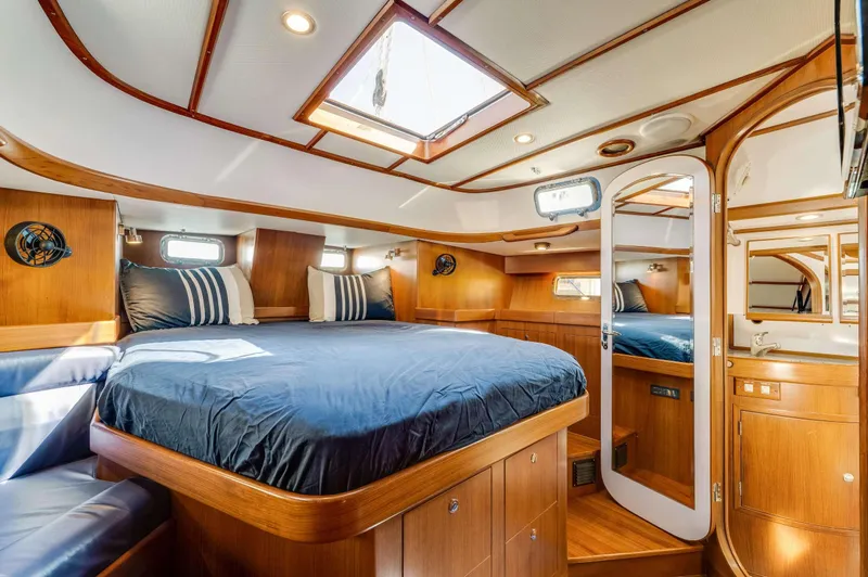 Liberte' Yacht Photos Pics Luxurious 2011 Hylas 46 yacht cabin with wood interior and skylight.