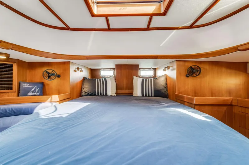Liberte' Yacht Photos Pics Luxurious cabin interior of 2011 Hylas 46 yacht with cozy bedding.