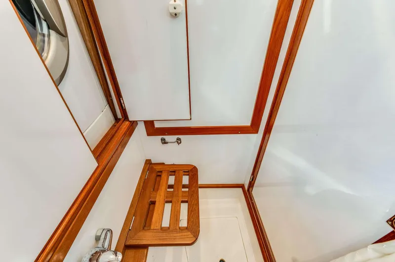 Liberte' Yacht Photos Pics Hylas 46 yacht interior, 2011 model, featuring wooden accents and compact design.