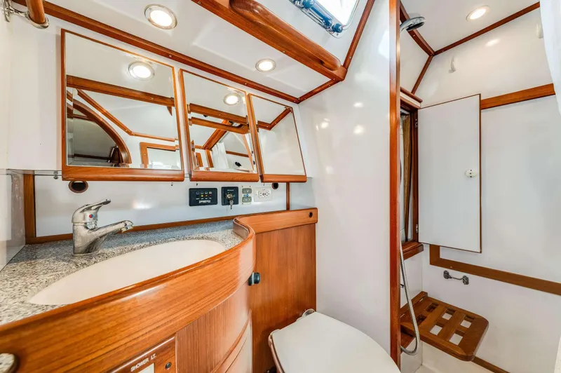 Liberte' Yacht Photos Pics Luxurious bathroom in 2011 Hylas 46 yacht with wood accents and modern fixtures.