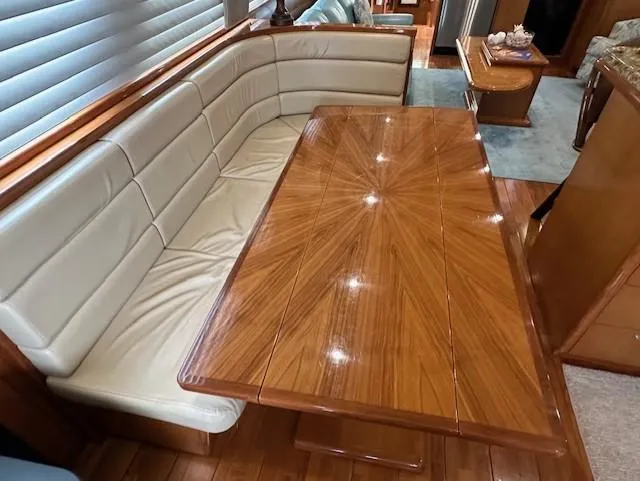 Perfect Fit Yacht Photos Pics Luxurious interior of 2000 Jefferson Marquessa 60 Cockpit yacht with elegant wood table and seating.