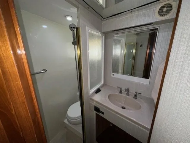 Perfect Fit Yacht Photos Pics Bathroom interior of 2000 Jefferson Marquessa 60 Cockpit yacht, featuring sink and shower.