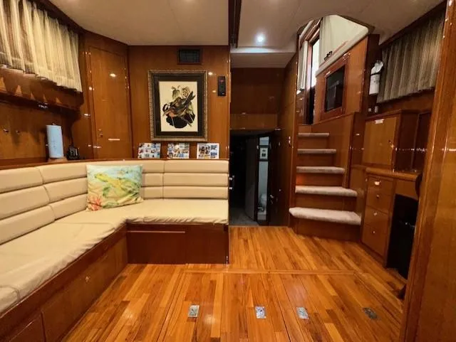 Perfect Fit Yacht Photos Pics Luxurious interior of 2000 Jefferson Marquessa 60 Cockpit yacht with wood flooring and plush seating.