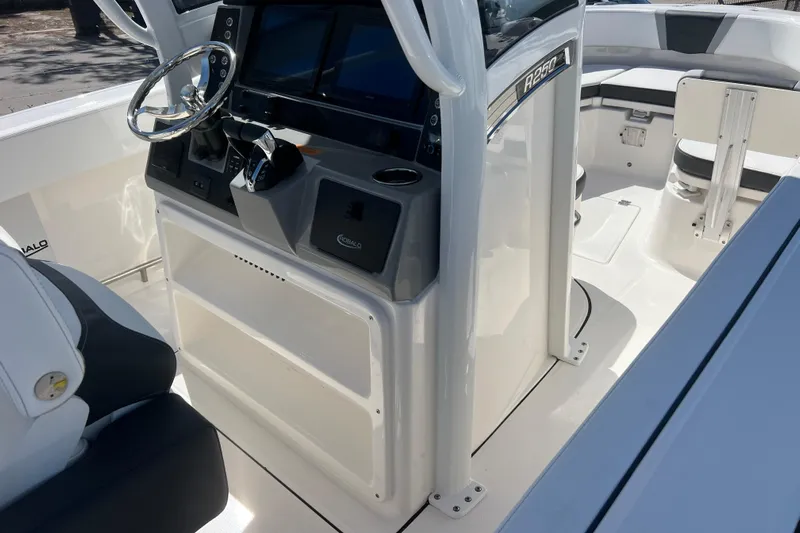  Yacht Photos Pics 2026 Robalo R250 Center Console boat interior with steering wheel and seating.