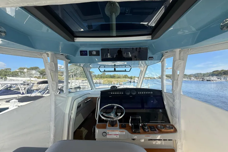  Yacht Photos Pics 2024 Boston Whaler 420 Outrage helm with advanced navigation system and panoramic marina view.