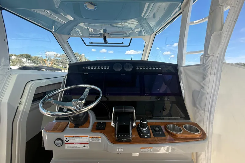  Yacht Photos Pics 2024 Boston Whaler 420 Outrage helm with modern controls and sleek design.