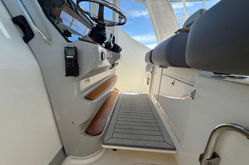  Yacht Photos Pics 2024 Boston Whaler 420 Outrage helm area with seating and control panel.