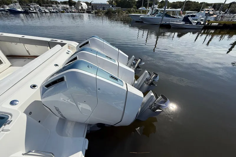  Yacht Photos Pics 2024 Boston Whaler 420 Outrage with triple outboard engines docked at marina.
