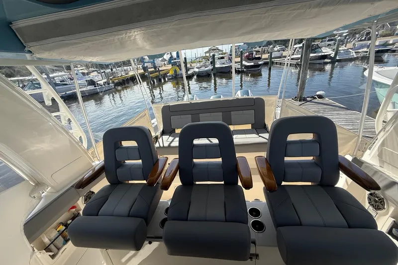  Yacht Photos Pics 2024 Boston Whaler 420 Outrage interior with luxurious seating and marina view.