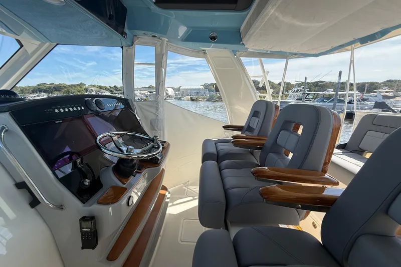  Yacht Photos Pics 2024 Boston Whaler 420 Outrage helm with luxurious seating and advanced navigation controls.