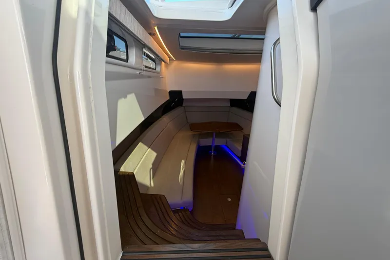  Yacht Photos Pics 2024 Boston Whaler 420 Outrage cabin interior with seating and ambient lighting.