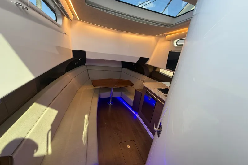  Yacht Photos Pics Luxurious interior of 2024 Boston Whaler 420 Outrage with seating and kitchenette.