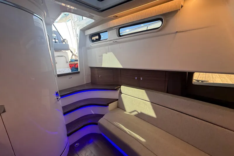  Yacht Photos Pics Interior of 2024 Boston Whaler 420 Outrage, featuring modern seating and ambient lighting.