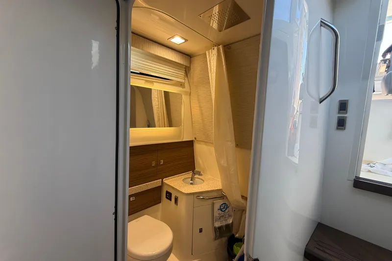  Yacht Photos Pics 2024 Boston Whaler 420 Outrage bathroom interior with modern fixtures and lighting.