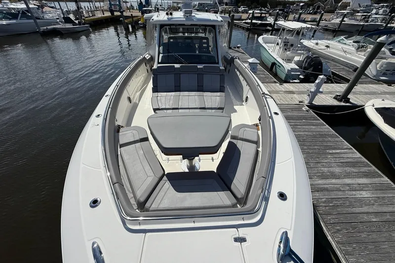  Yacht Photos Pics 2024 Boston Whaler 420 Outrage boat docked, featuring spacious seating and sleek design.
