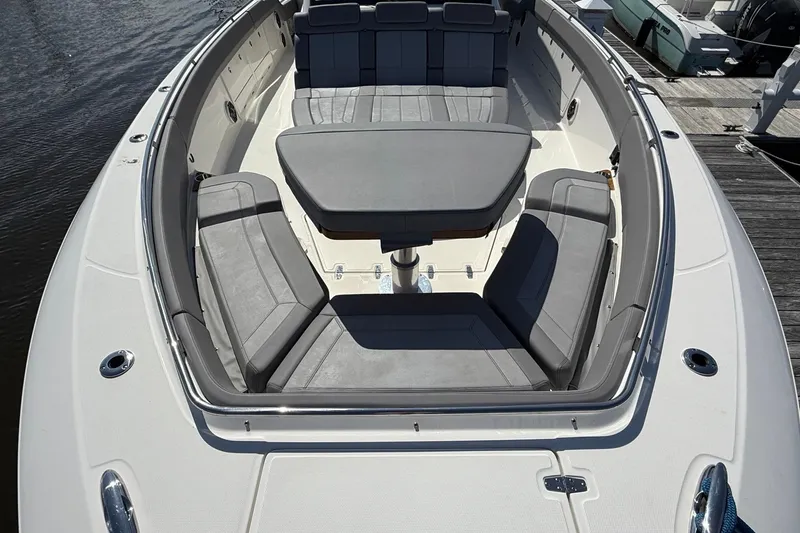  Yacht Photos Pics 2024 Boston Whaler 420 Outrage boat with spacious seating and table on deck.