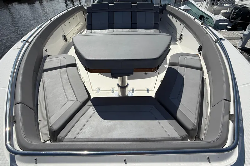  Yacht Photos Pics 2024 Boston Whaler 420 Outrage boat interior with gray seating and table.