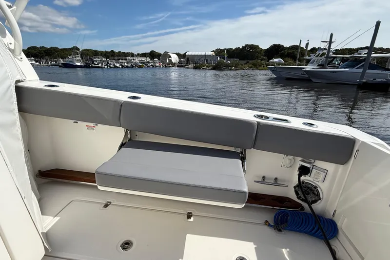  Yacht Photos Pics 2024 Boston Whaler 420 Outrage boat interior with seating and marina view.