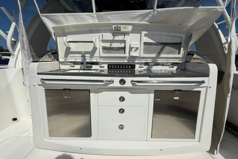 Yacht Photos Pics 2024 Boston Whaler 420 Outrage boat interior with sleek kitchen setup and storage compartments.