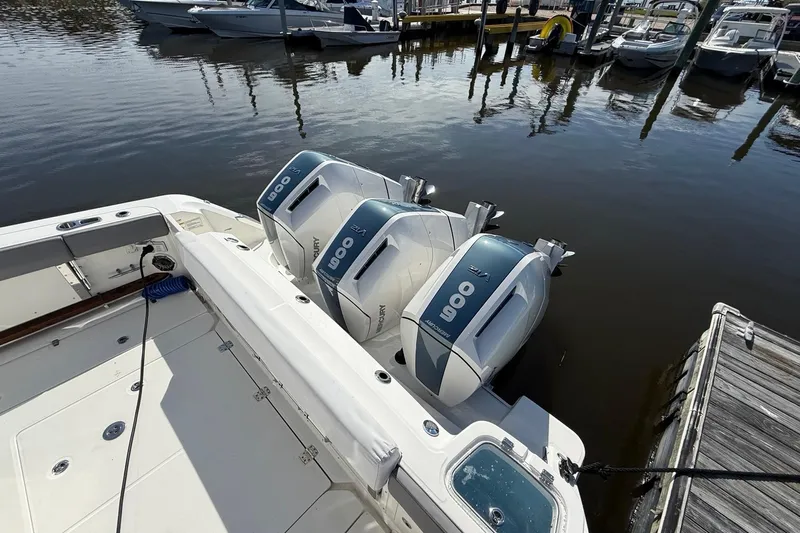  Yacht Photos Pics 2024 Boston Whaler 420 Outrage with triple Mercury 600 engines docked at marina.
