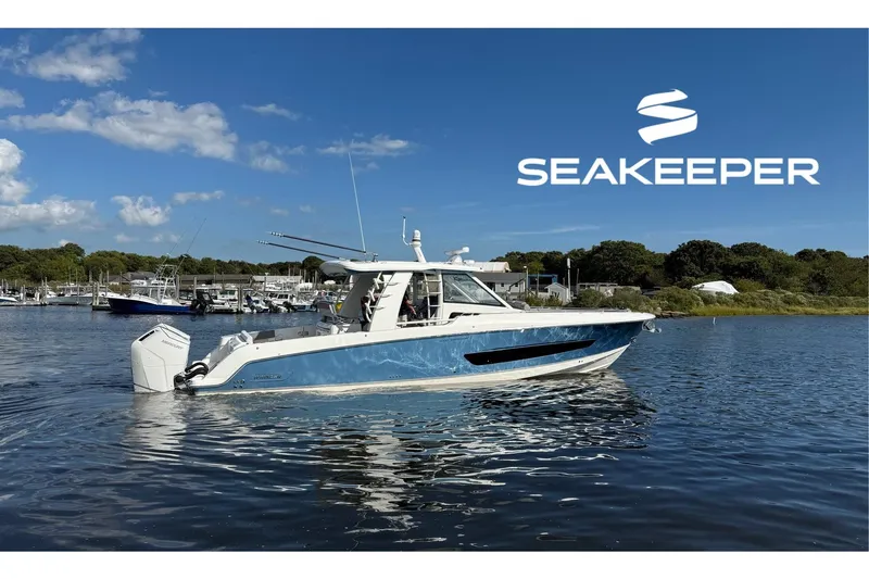  Yacht Photos Pics 2024 Boston Whaler 420 Outrage boat on water, featuring Seakeeper technology.