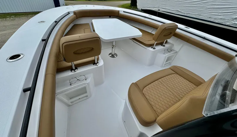  Yacht Photos Pics 2020 Southport 33 FE boat interior with tan leather seating and a white table.