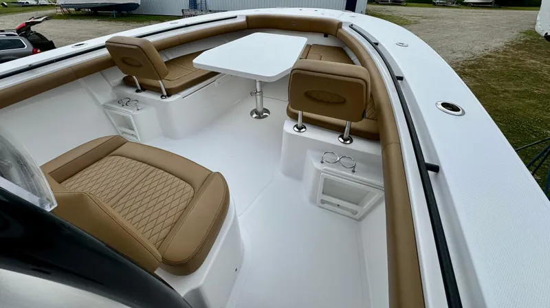  Yacht Photos Pics 2020 Southport 33 FE boat interior with tan seating and white table.