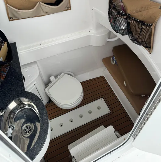  Yacht Photos Pics 2020 Southport 33 FE boat interior with sink, toilet, and storage compartments.