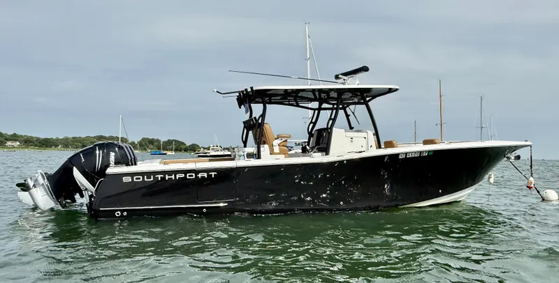  Yacht Photos Pics 2020 Southport 33 FE boat on water, side view, with outboard motors.