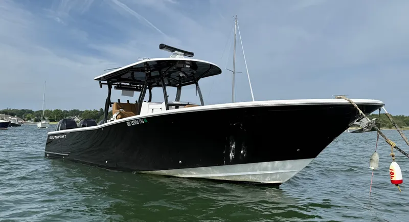  Yacht Photos Pics 2020 Southport 33 FE boat on water, black hull, clear sky background.