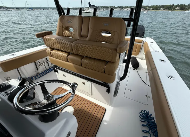  Yacht Photos Pics 2020 Southport 33 FE boat interior with tan seating and steering wheel, docked on water.