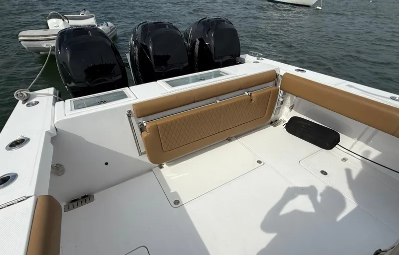  Yacht Photos Pics 2020 Southport 33 FE boat with triple outboard engines and tan seating on the deck.