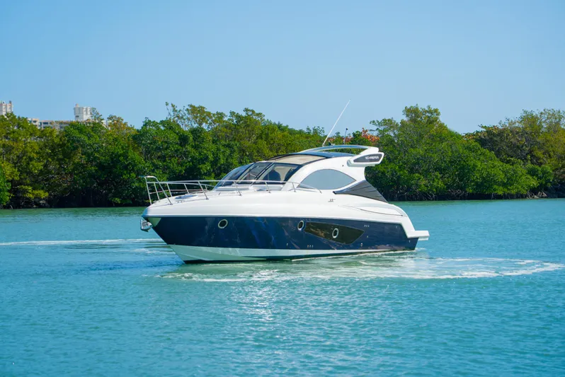  Yacht Photos Pics 2022 Schaefer 375 HT yacht cruising on a serene blue waterway.