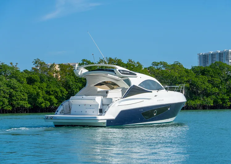  Yacht Photos Pics Schaefer 375 HT 2022 yacht cruising on a serene blue waterway.