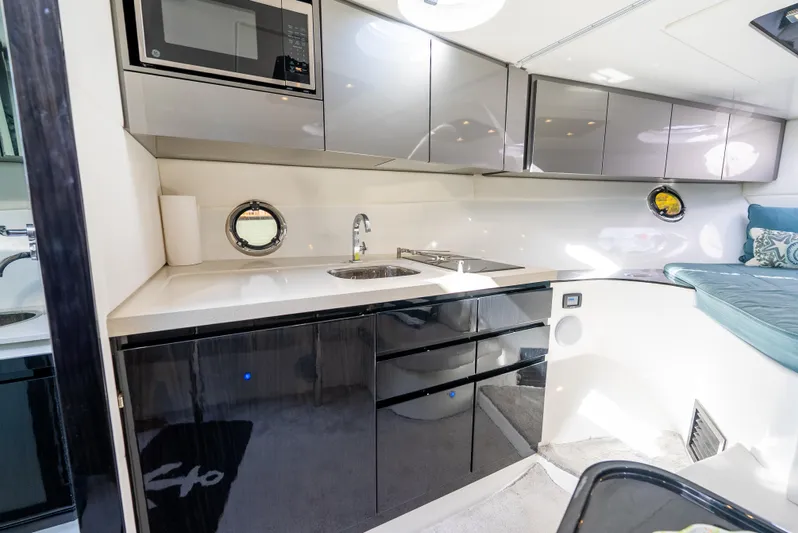  Yacht Photos Pics Modern kitchen interior of 2022 Schaefer 375 HT yacht with sleek cabinetry and portholes.