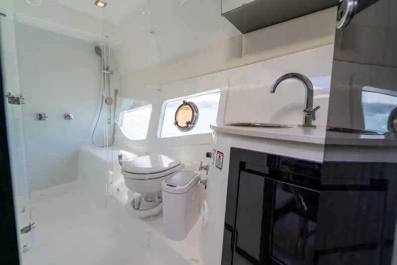  Yacht Photos Pics Modern bathroom interior on 2022 Schaefer 375 HT yacht, featuring shower, toilet, and sink.
