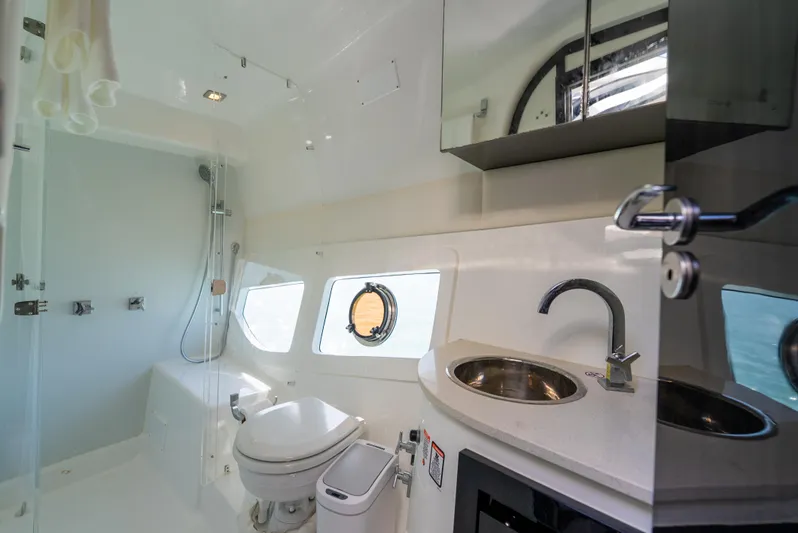  Yacht Photos Pics Modern bathroom interior on 2022 Schaefer 375 HT yacht, featuring sleek fixtures and porthole windows.