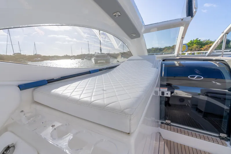  Yacht Photos Pics 2022 Schaefer 375 HT yacht interior with white cushioned seating and scenic water view.