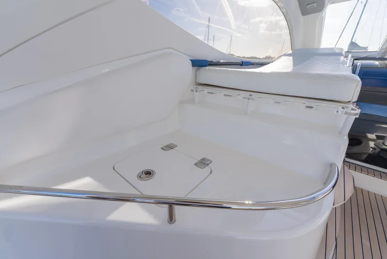  Yacht Photos Pics 2022 Schaefer 375 HT yacht interior with sleek white seating and polished metal railing.