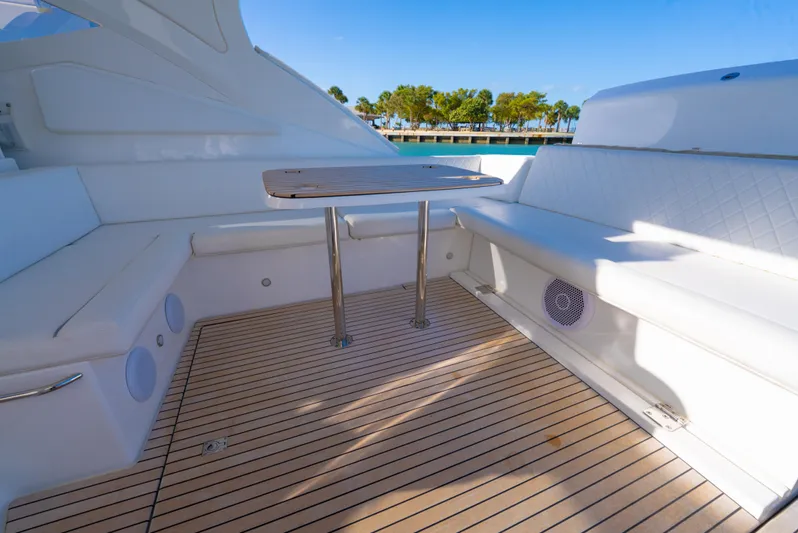  Yacht Photos Pics Schaefer 375 HT 2022 yacht deck with seating and table, featuring sleek design and wood flooring.