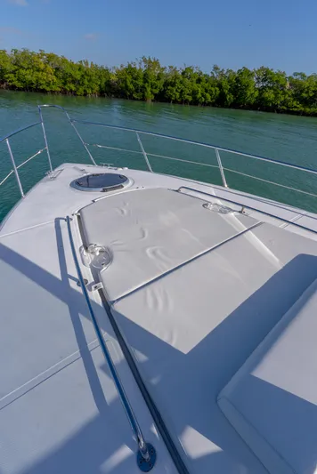  Yacht Photos Pics 2022 Schaefer 375 HT yacht deck with sunbathing area, surrounded by serene water and lush greenery.