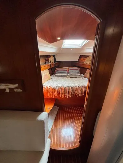  Yacht Photos Pics Cozy cabin interior of 2002 Jeanneau Sun Odyssey 40 sailboat with wooden flooring.