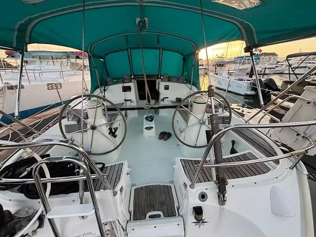  Yacht Photos Pics Cockpit of 2002 Jeanneau Sun Odyssey 40 sailboat with dual steering wheels and teal canopy.