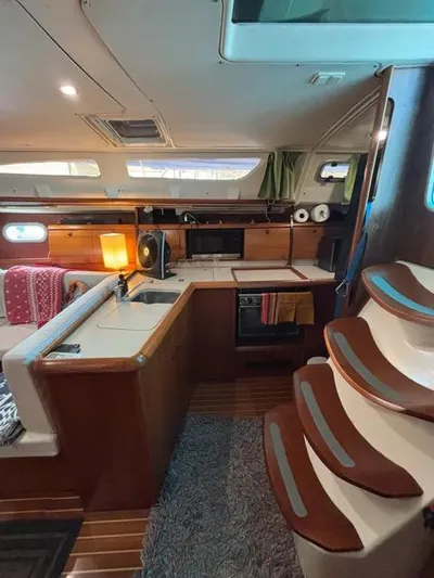  Yacht Photos Pics Interior of 2002 Jeanneau Sun Odyssey 40 sailboat with kitchen and stairs.