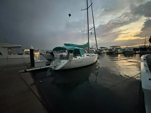  Yacht Photos Pics Jeanneau Sun Odyssey 40 sailboat docked at sunset, 2002 model, serene marina setting.