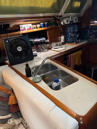  Yacht Photos Pics Interior of 2002 Jeanneau Sun Odyssey 40 yacht with kitchen sink and fan.