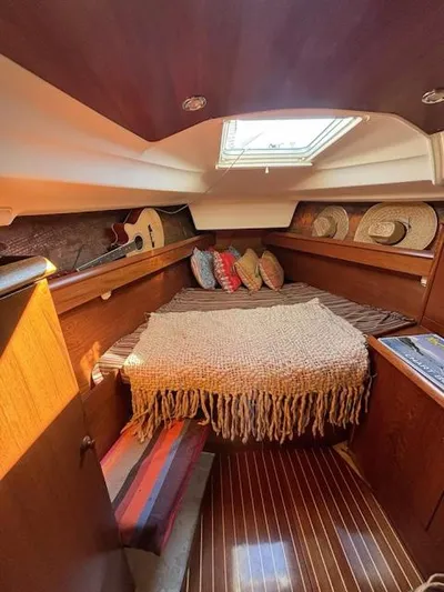 Yacht Photos Pics Cozy cabin interior of 2002 Jeanneau Sun Odyssey 40 sailboat with bed and skylight.