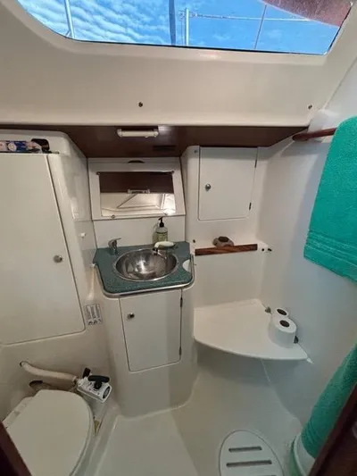  Yacht Photos Pics Interior of 2002 Jeanneau Sun Odyssey 40 yacht bathroom with sink, toilet, and storage.