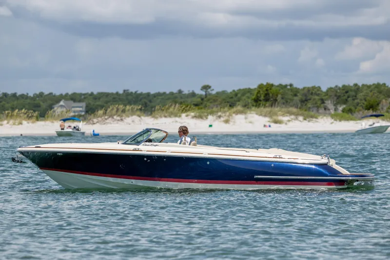  Yacht Photos Pics 2022 Chris-Craft Launch 27 boat cruising on a scenic waterway.